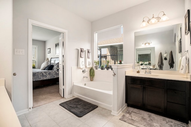 bathroom featuring tile patterned floors, a tub, and vanity