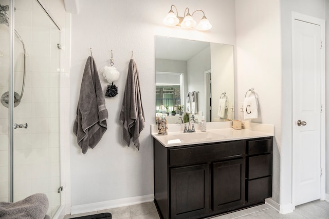 bathroom featuring tile patterned flooring, vanity, and a shower with door