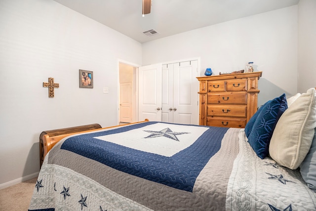 carpeted bedroom with a closet and ceiling fan