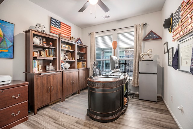 office space with light hardwood / wood-style floors and ceiling fan