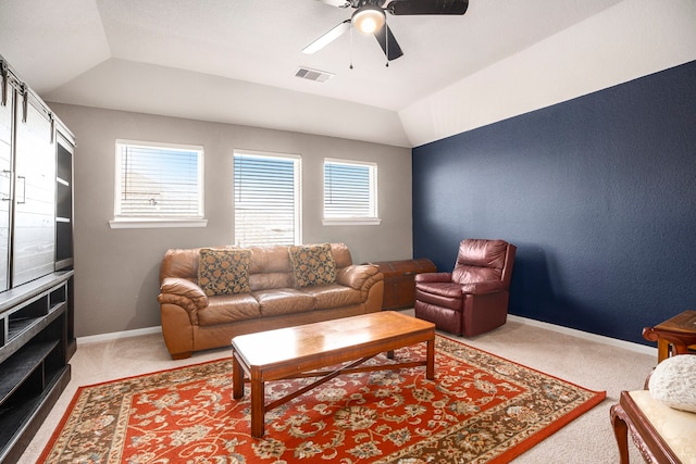 carpeted living room with a wealth of natural light, ceiling fan, and lofted ceiling