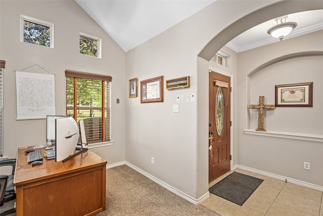 office with lofted ceiling, crown molding, and light tile patterned floors