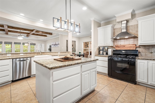 kitchen with black gas stove, dishwasher, a center island, beam ceiling, and wall chimney exhaust hood