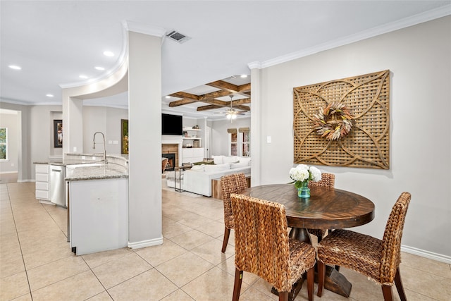 tiled dining area with coffered ceiling, sink, beam ceiling, and ornamental molding