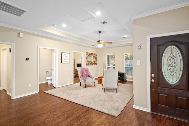 entrance foyer with ornamental molding, ceiling fan, and dark hardwood / wood-style floors