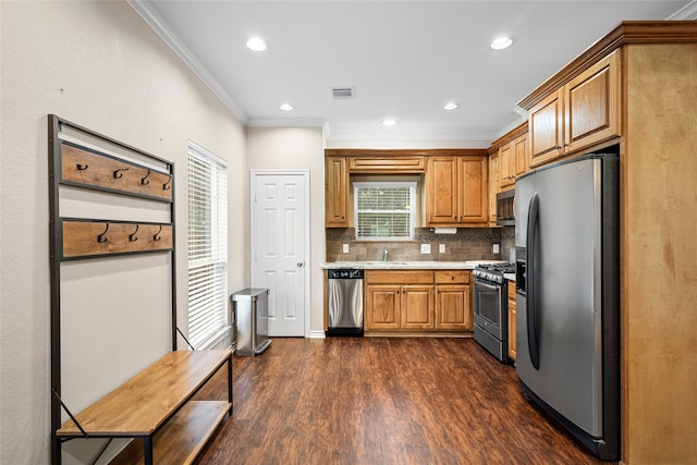 kitchen featuring backsplash, stainless steel appliances, ornamental molding, dark hardwood / wood-style floors, and sink