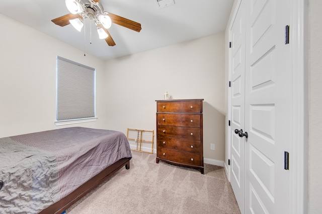 carpeted bedroom featuring a closet and ceiling fan