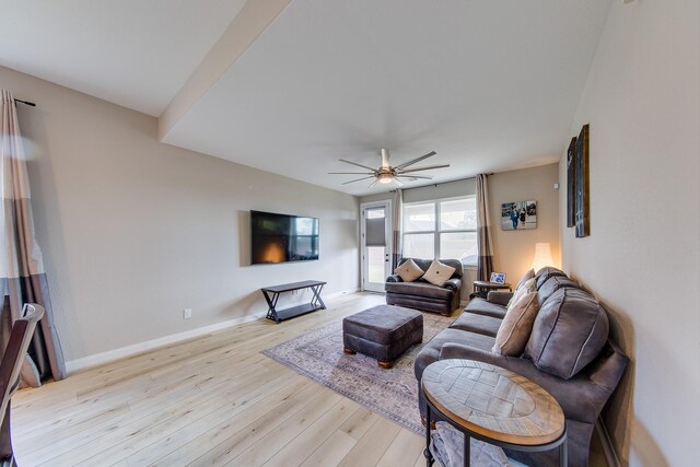 living room with ceiling fan and light wood-type flooring