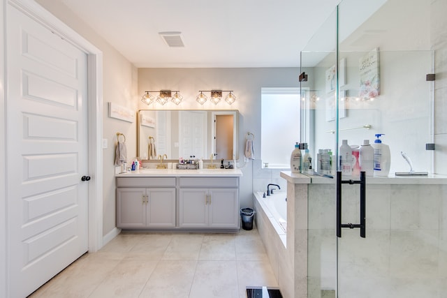 bathroom featuring tile patterned floors, vanity, and plus walk in shower