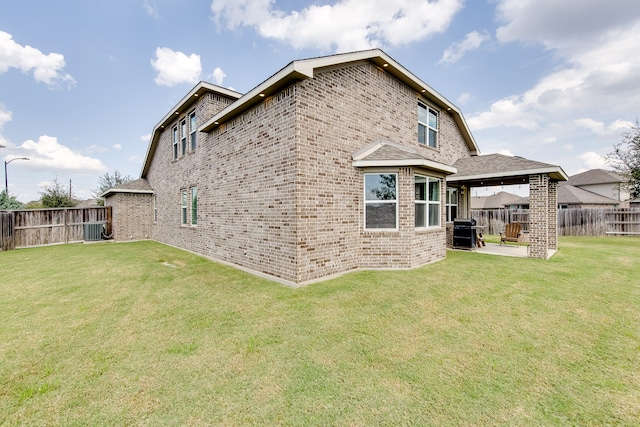 back of property with a patio, a yard, and cooling unit