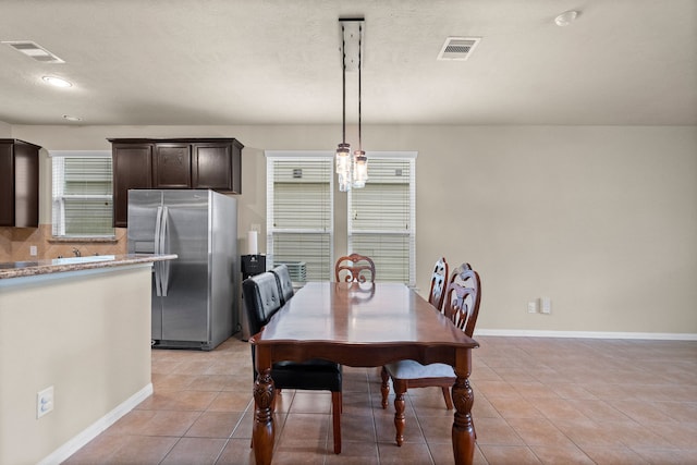 dining space with light tile patterned floors