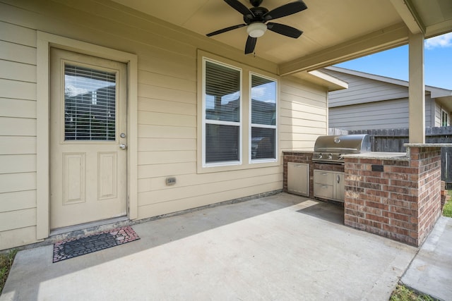 view of patio featuring ceiling fan, area for grilling, and grilling area