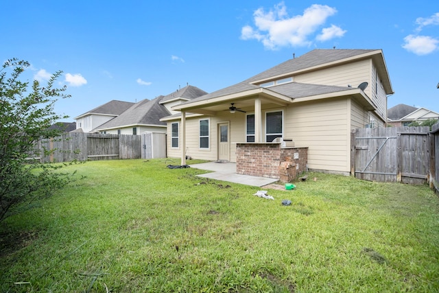 back of house featuring ceiling fan, a patio area, and a yard