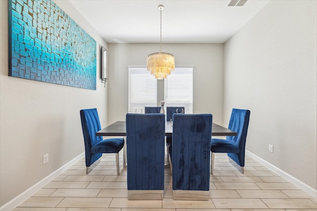 dining room featuring an inviting chandelier and light wood-type flooring