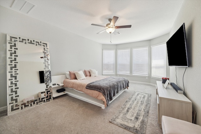 bedroom with ceiling fan, carpet floors, and a textured ceiling