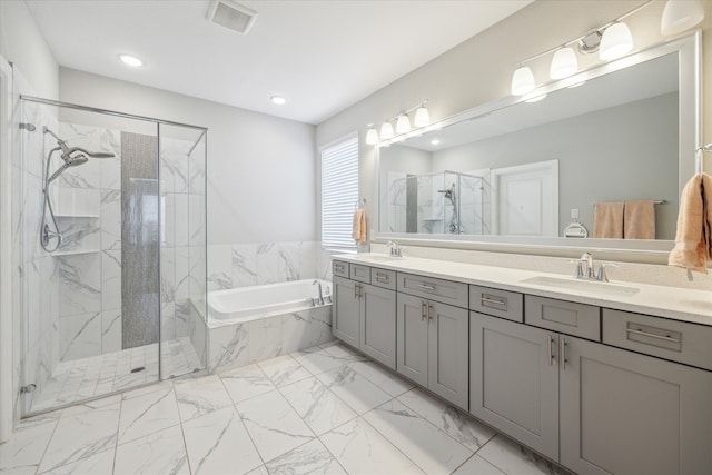 bathroom featuring vanity and shower with separate bathtub