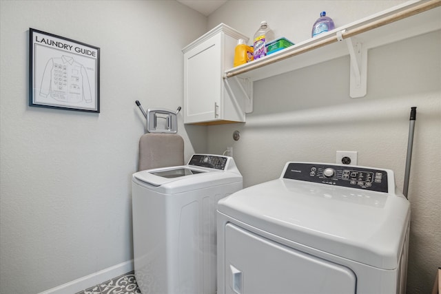 laundry room with cabinets and washing machine and clothes dryer