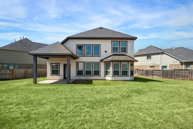 rear view of house with a yard and a patio area