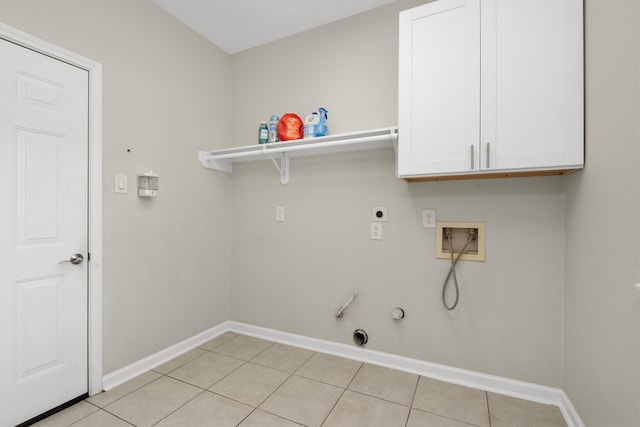 laundry area with gas dryer hookup, washer hookup, light tile patterned floors, and cabinets