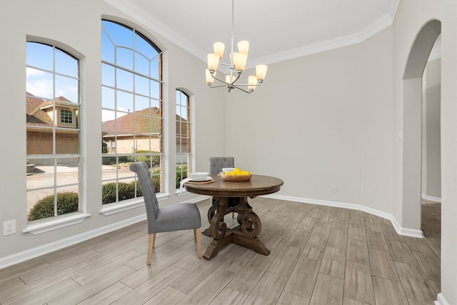 dining room with a healthy amount of sunlight, crown molding, and light hardwood / wood-style flooring