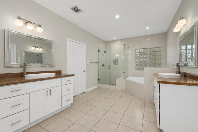 bathroom with plus walk in shower, tile patterned flooring, and vanity