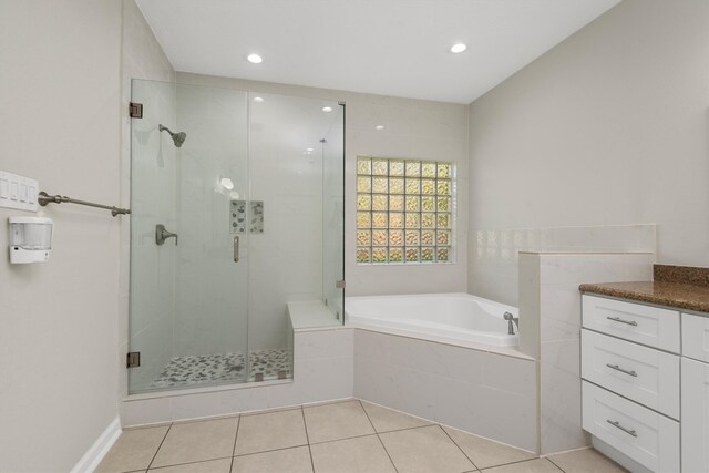 bathroom featuring shower with separate bathtub, tile patterned floors, and vanity