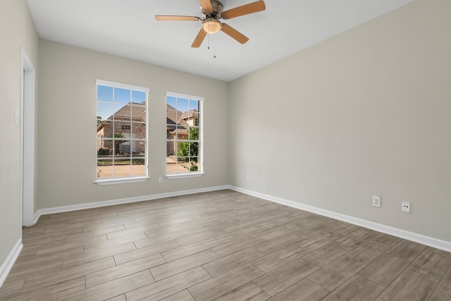 empty room with ceiling fan and light wood-type flooring