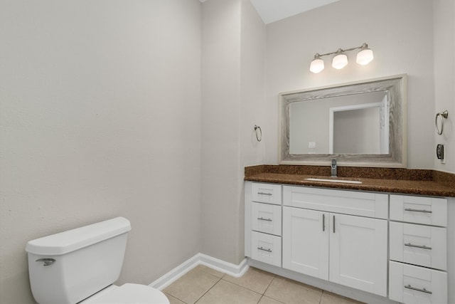 bathroom with vanity, toilet, and tile patterned floors