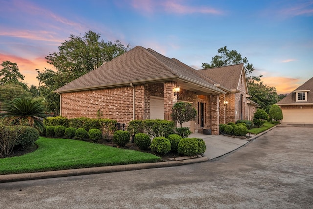 view of front of property with a lawn and a garage