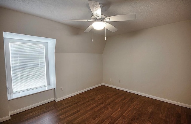 bonus room featuring ceiling fan, a textured ceiling, lofted ceiling, and dark hardwood / wood-style flooring