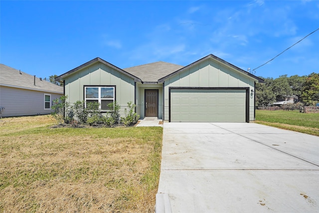 single story home with a garage and a front lawn