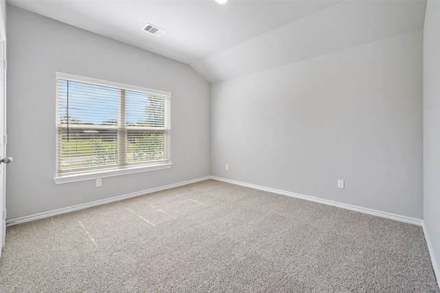 spare room with lofted ceiling and carpet flooring