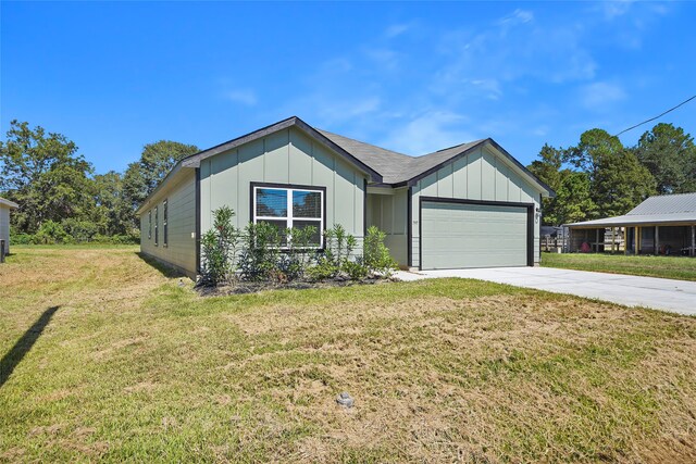 view of front of property featuring a garage and a front lawn