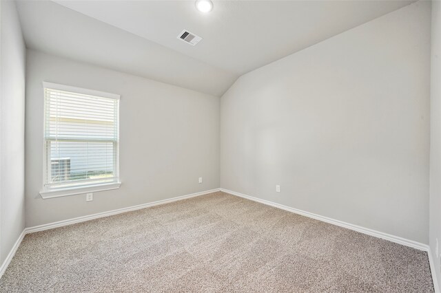 unfurnished room with carpet floors and lofted ceiling