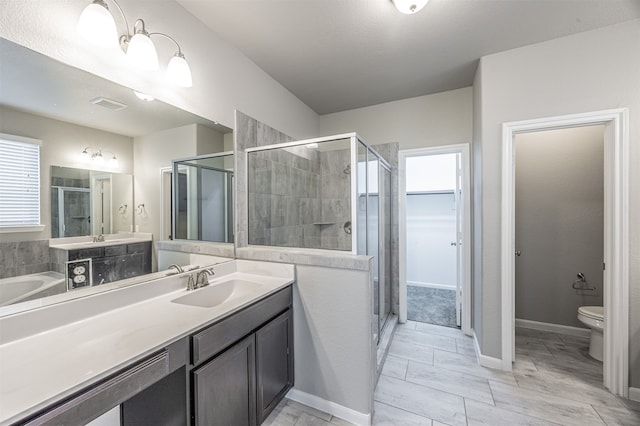 full bathroom with shower with separate bathtub, vanity, and toilet