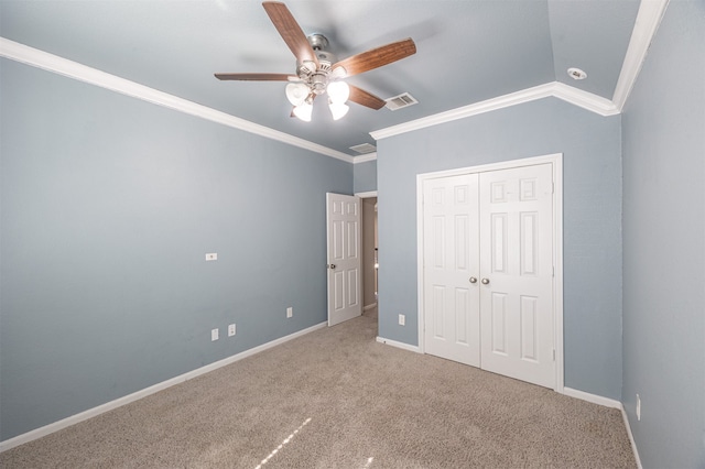 unfurnished bedroom with ornamental molding, lofted ceiling, carpet, and ceiling fan