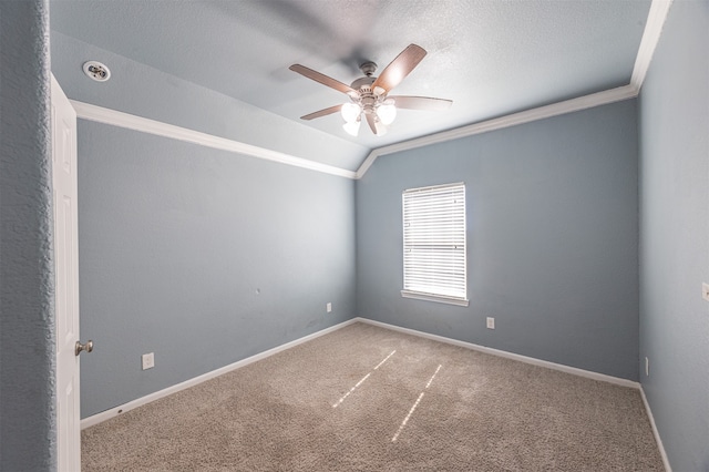 spare room with vaulted ceiling, a textured ceiling, ceiling fan, carpet, and ornamental molding