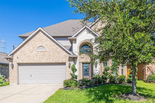 view of front of property with a front yard and a garage