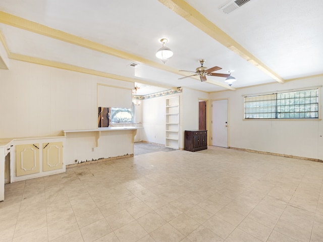 empty room with beamed ceiling and ceiling fan