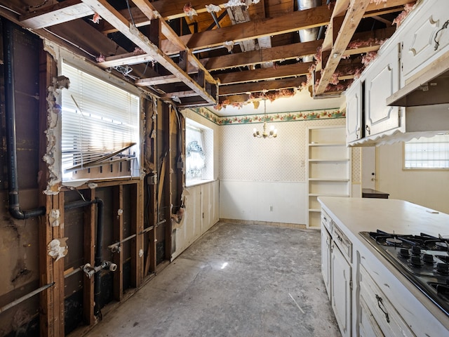 kitchen with black gas stovetop and white cabinets