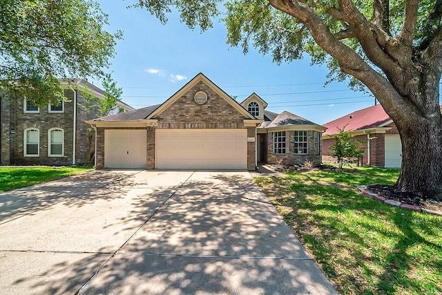 view of front of property featuring a garage and a front yard