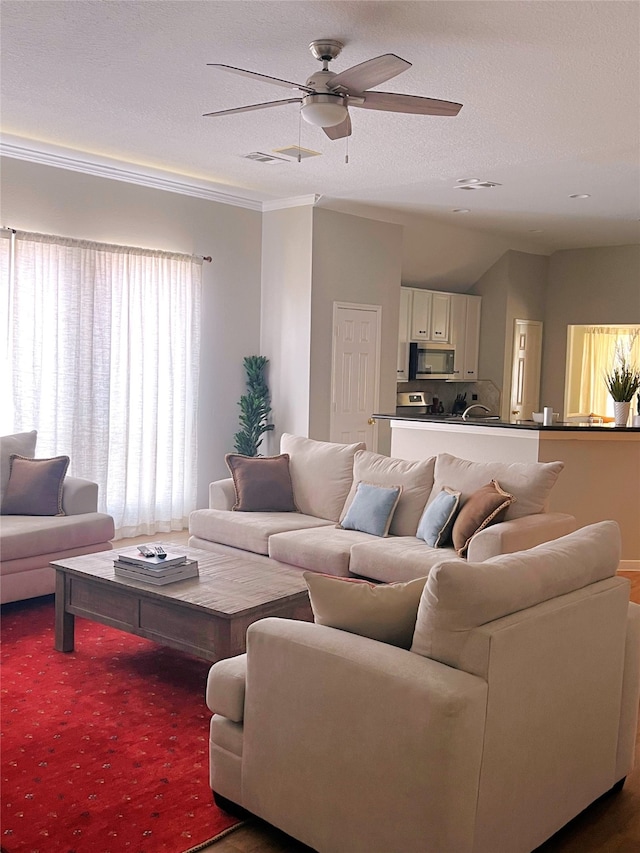 living room featuring ornamental molding and ceiling fan