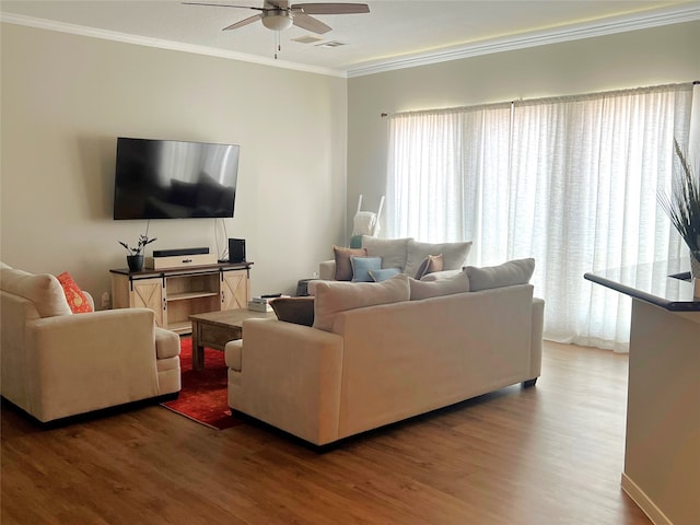 living room with ornamental molding, dark hardwood / wood-style flooring, and ceiling fan