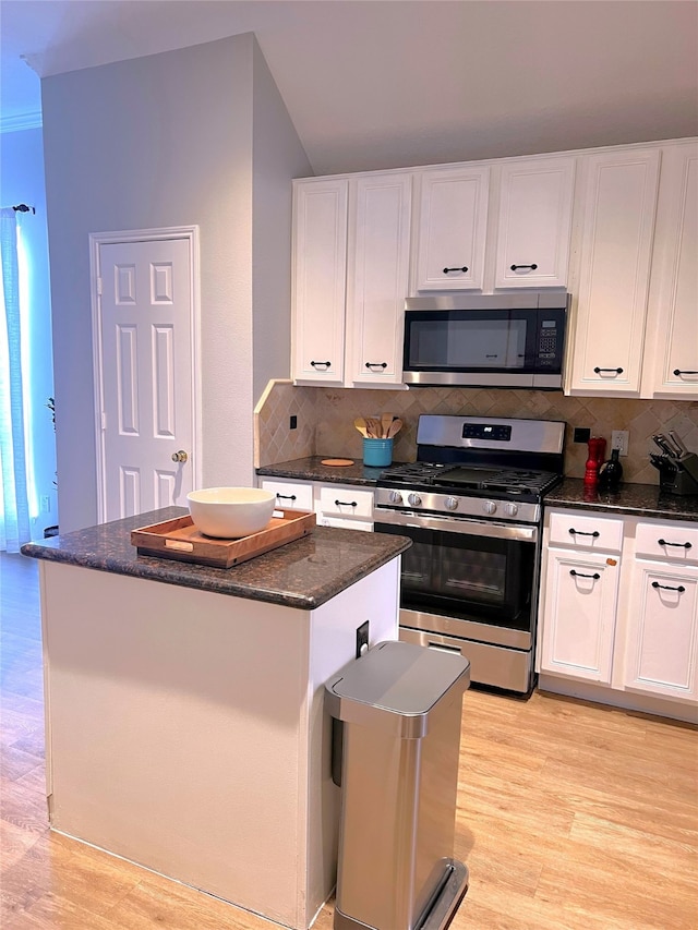 kitchen with light hardwood / wood-style floors, a center island, stainless steel appliances, and white cabinets