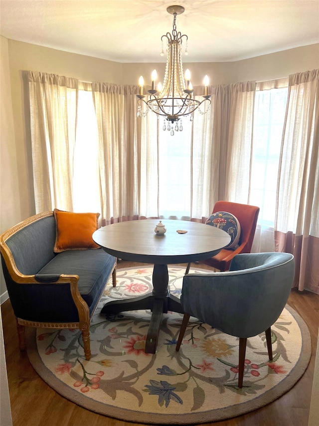 dining room with an inviting chandelier and hardwood / wood-style floors