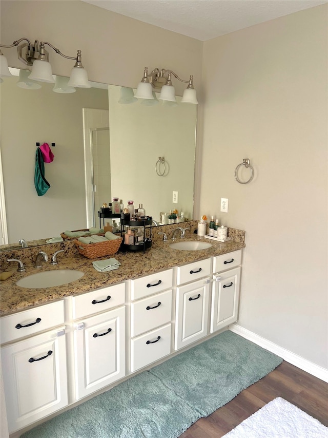 bathroom with hardwood / wood-style flooring and vanity