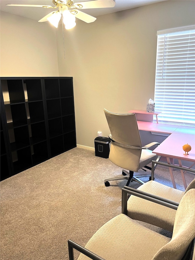 office area with ceiling fan and carpet flooring