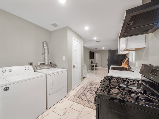 laundry area with washing machine and dryer and sink