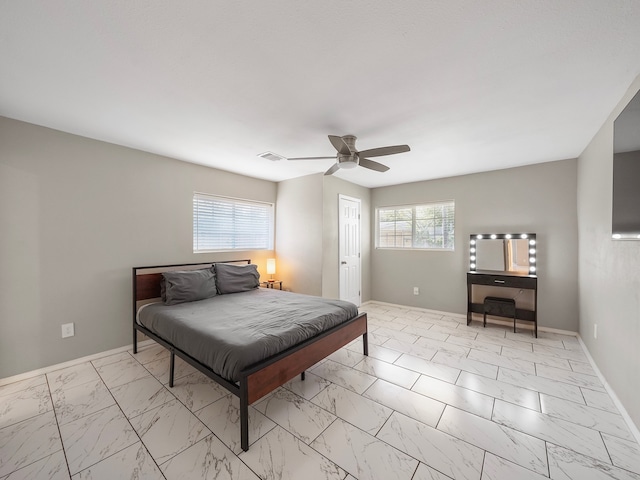 bedroom featuring ceiling fan and multiple windows