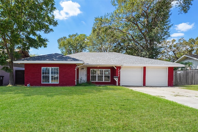 ranch-style house with a garage and a front lawn